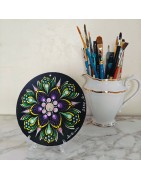Transparent CD holder displaying a painted CD on a table